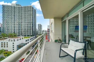 a balcony with a chair and a view of a city at Midtown Muse -Walkable Cozy amenity bldg w parking in Miami