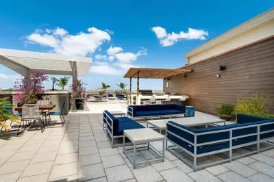 a patio with blue furniture and a table and chairs at Midtown Muse -Walkable Cozy amenity bldg w parking in Miami