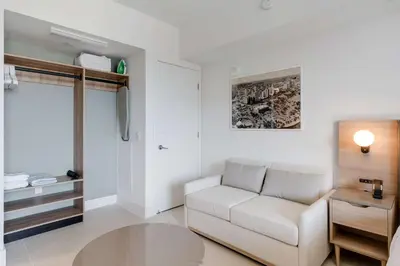 a living room with a white couch and a table at Bellini Breeze - Cozy Central Miami Pool and Gym in Miami
