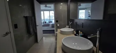 a bathroom with a sink and a toilet and a mirror at Miami brickell condo ocean view in Miami