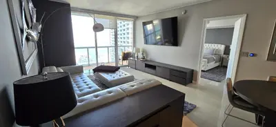 a living room with a white couch and a television at Miami brickell condo ocean view in Miami