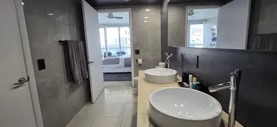 a bathroom with a sink and a toilet and a mirror at Miami brickell condo ocean view in Miami
