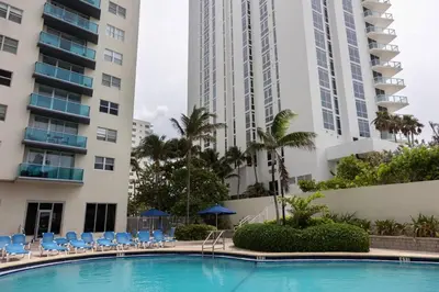 a swimming pool in front of two tall buildings at Beachfront 1 BR Apartment with Kitchen- Sian in Hollywood