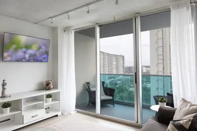 a living room with a couch and a large window at Beachfront 1 BR Apartment with Kitchen- Sian in Hollywood