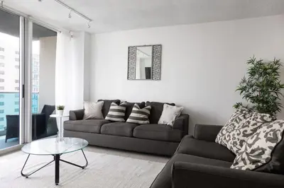 a living room with a couch and a table at Beachfront 1 BR Apartment with Kitchen- Sian in Hollywood