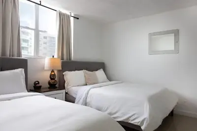 a hotel room with two beds and a window at Beachfront 1 BR Apartment with Kitchen- Sian in Hollywood