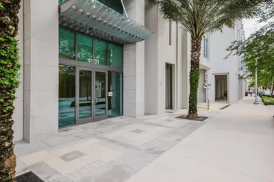 a sidewalk in front of a building with a palm tree at Blueground Brickell pool wd near city center MIA-127 in Miami