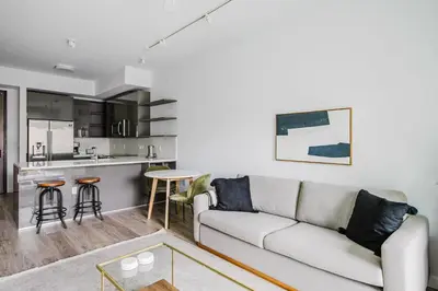 a living room with a couch and a kitchen at Blueground Brickell pool wd near city center MIA-127 in Miami