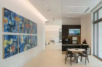 a living room with a large painting on the wall at Blueground Brickell pool wd near city center MIA-127 in Miami