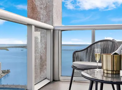 a balcony with a table and a glass of wine at MVR-Relax in Style Above Brickell in Miami