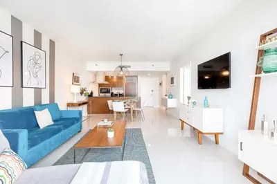 a living room with a blue couch and a table at MVR-Corner Unit w Epic Views in Miami