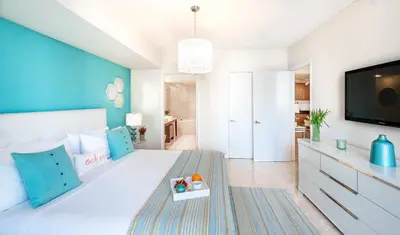 a bedroom with a white bed with a blue wall at MVR-Icon Brickell High-Rise w Balcony in Miami