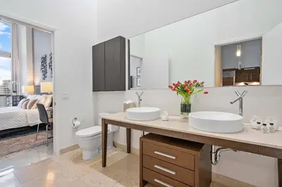 a bathroom with two sinks and a toilet at MVR-Water Views & Modern Luxury in Miami