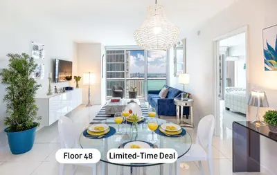 a living room with a dining table and a kitchen at MVR - Stylish Stay w Resort Access in Miami