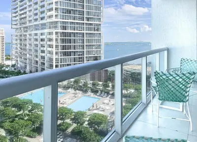 a balcony with a chair and a view of a building at MVR - Magnificent Bay & River Views SPA Balcony in Miami