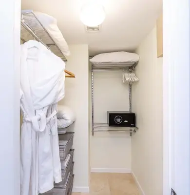 a walk in closet with a camera and towels at MVR - Brickell Icon w Massive Pool & Spa in Miami