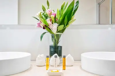a vase of flowers on a counter in a bathroom at MVR - Designer Condo in Prime Brickell in Miami