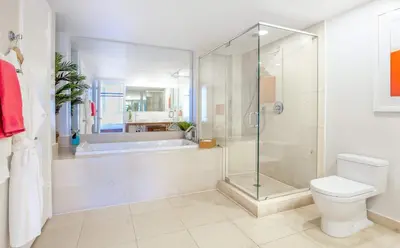 a bathroom with a shower and a toilet and a tub at MVR - Wake to Water & Skyline Views in Miami