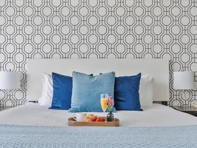 a bed with blue pillows and a tray of fruit on it at MVR - High-Rise Escape with Spa Access in Miami