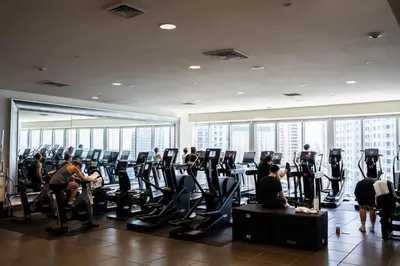 a group of people exercising in a gym at MVR - Stylish Escape in Icon Brickell in Miami