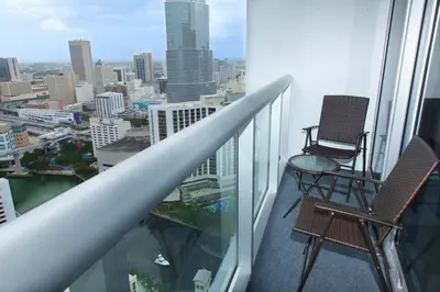 a balcony with two chairs and a view of a city at MVR - River & City Views Brickell Center LuxSPA in Miami