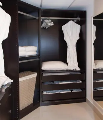 a black closet with white shirts and towels at MVR - River & City Views Brickell Center LuxSPA in Miami