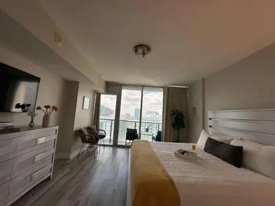 a bedroom with a large bed and a large window at MVR - Live the Icon Brickell Dream in Miami