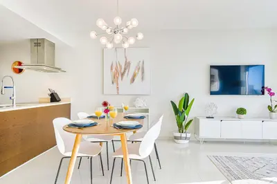 a dining room with a table and white chairs at MVR - High-End Condo with Miami Views in Miami