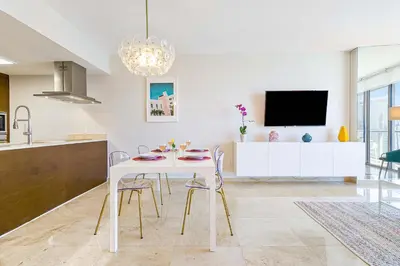 a kitchen and dining room with a white table and chairs at MVR - Top-Tier Brickell High-Rise Stay in Miami