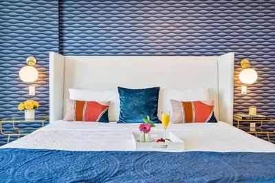 a bedroom with a large white bed with colorful pillows at MVR - Top-Tier Brickell High-Rise Stay in Miami