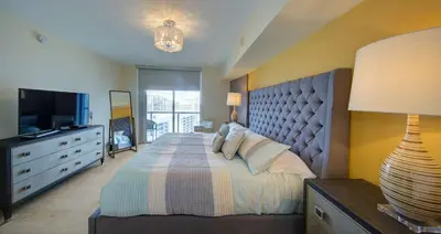 a bedroom with a large bed and a television at MVR Balcony Bliss in Miami in Miami