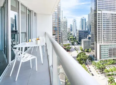 a balcony with a table and a view of a city at MVR - Luxury & Location at Icon Brickell in Miami