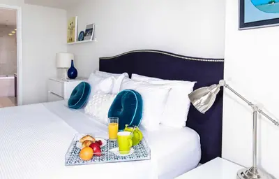 a bed with a tray of fruit and drinks on it at MVR Luxury Condo High Floor European Design in Miami