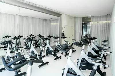 a gym with a row of treadmills at MVR - Designer Stay in Sky-High Tower in Miami