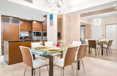 a dining room and kitchen with a table and chairs at MVR - Designer Stay in Sky-High Tower in Miami