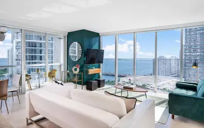 a living room with a white couch and large windows at MVR - Luxury Tower Stay with Miami Views in Miami
