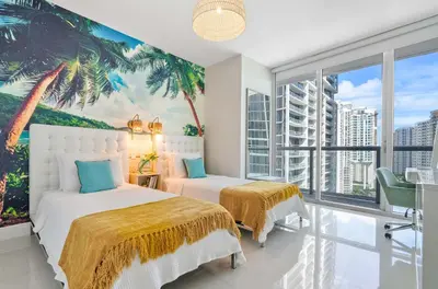 a bedroom with two beds and a palm tree mural at MVR - Brickell Views - Spa & Style in Miami