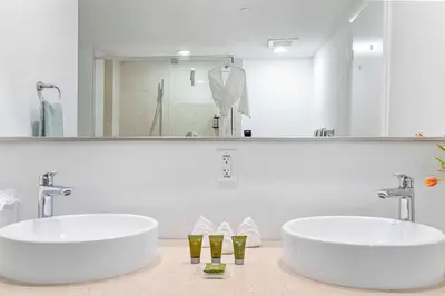 two sinks in a bathroom with a large mirror at MVR - Brickell Views - Spa & Style in Miami