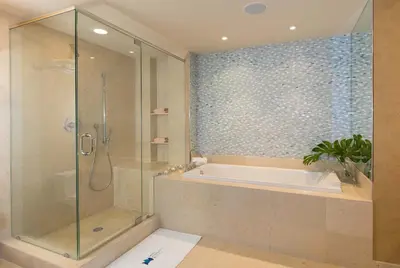 a bathroom with a tub and a glass shower at MVR - Oceanfront Corner Balcony Luxe SPA in Miami