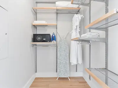 a walk in closet with metal shelving at MVR - Bay & City Views from the 45th in Miami
