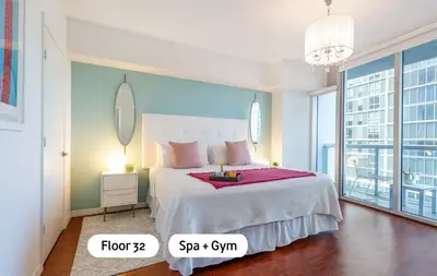 a bedroom with a large bed and a large window at MVR - Soaring Views & Spa Access in Miami