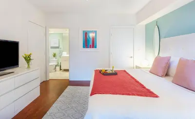 a bedroom with a bed with a television and a bathroom at MVR - Soaring Views & Spa Access in Miami