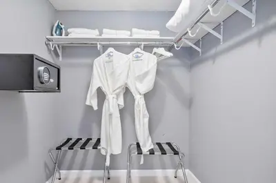 a closet with white clothes hanging on a rack at MVR - Icon Brickell & King Suite Views in Miami