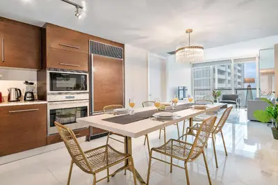 a kitchen and dining room with a table and chairs at MVR - Icon Brickell & King Suite Views in Miami