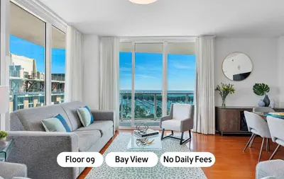 a living room with a couch and a large window at MVR - Coconut Grove-s Oasis of Comfort and Elegance in Miami