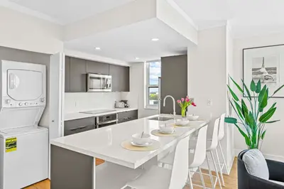 a white kitchen with a white table and chairs at MVR - Grove-s Best Stay Near Everything You Want in Miami