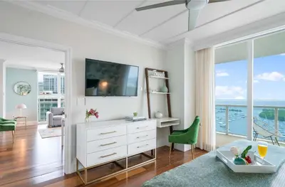a living room with a white dresser and a tv at MVR - Views You-ll Brag About for Years in Miami