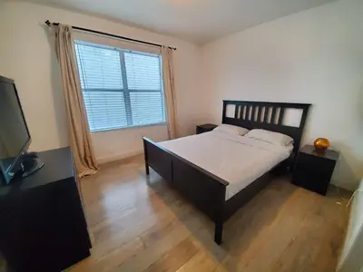 a bedroom with a bed and a large window at 1 Bed on Collins Av close to Beach in Miami Beach