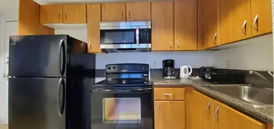 a kitchen with a stainless steel refrigerator and a microwave at 1 Bed on Collins Av close to Beach in Miami Beach