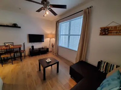 a living room with a couch and a table at 1 Bed on Collins Av close to Beach in Miami Beach